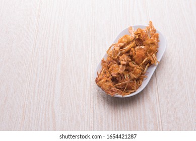 A Serving Of Fried Baby Crab,a Traditional And Famous Street Found Isolated Over Wooden/white Background.