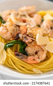 Serving Garlic Shrimp Pasta With Spinach In White Ceramic Bowls.