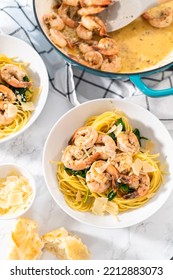 Serving Garlic Shrimp Pasta With Spinach In White Ceramic Bowls.