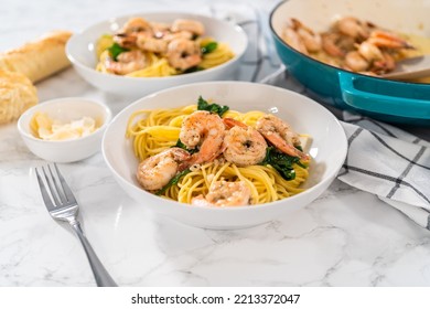 Serving Garlic Shrimp Pasta With Spinach In White Ceramic Bowls.