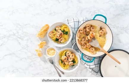 Serving Garlic Shrimp Pasta With Spinach In White Ceramic Bowls.