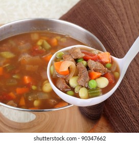 Serving In A Ladle Of Vegetable Beef Soup