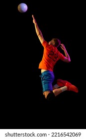 Serving. Male Professional Volleyball Player In Sports Uniform Training With Ball Isolated On Dark Background. Sportive Man Playing Volleyball. Action, Sport, Health, Team, Fitness Concept