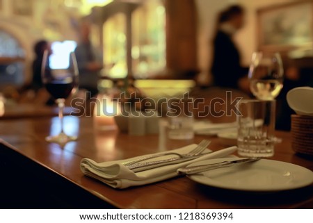 serving in the restaurant, fork and knife / interior view of the restaurant with a table served knife and fork on the table in a cafe