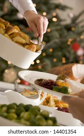 Serving Roast Potatoes At Christmas Lunch