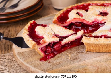 Serving a slice of cherry pie on a wooden platter