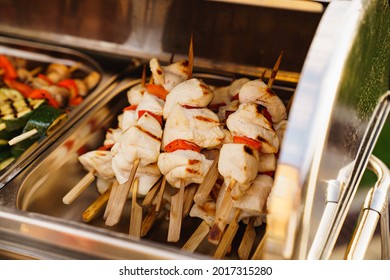 Serving Small Hot Chicken Kebabs On The Buffet. Catering For A Dinner Party On The Outdoors. Delivery Of Meals And Banquet Service.