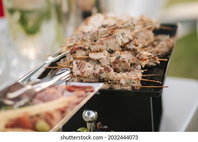 Serving Small Hot Chicken And Red Fish Kebabs On The Buffet. Catering For A Dinner Party On The Outdoors. Open Air Food Concept