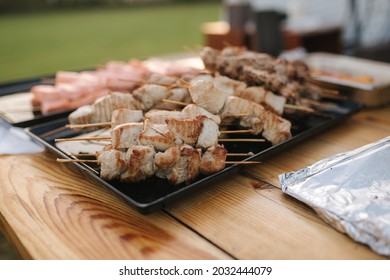 Serving Small Hot Chicken And Red Fish Kebabs On The Buffet. Catering For A Dinner Party On The Outdoors. Open Air Food Concept