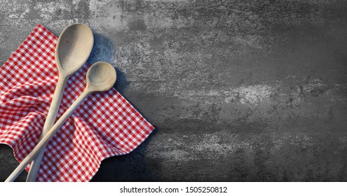 Serving spoons on checkered cloth lying on stone surface - Powered by Shutterstock