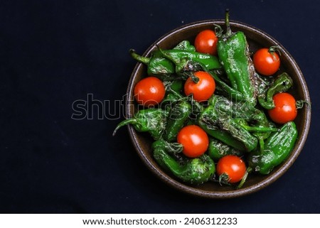 Serving suggestion of fresh, green Galician peppers Pimientos de Padron