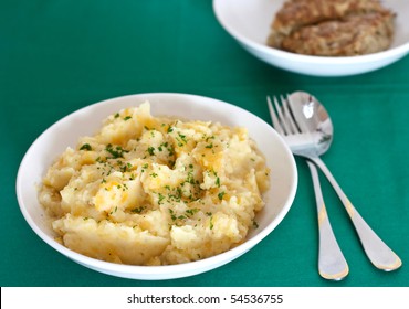 Serving Of Tatties And Neeps With Haggis Behind