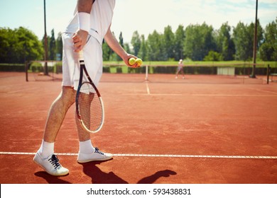 Serving tennis ball at dross court