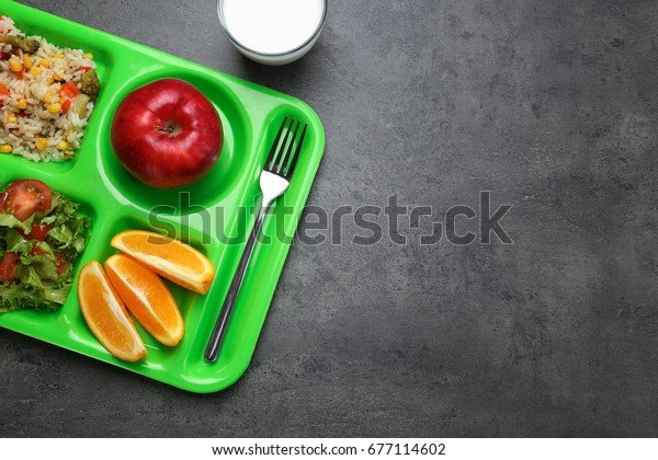 Serving tray with delicious food on table. Concept\
of school lunch