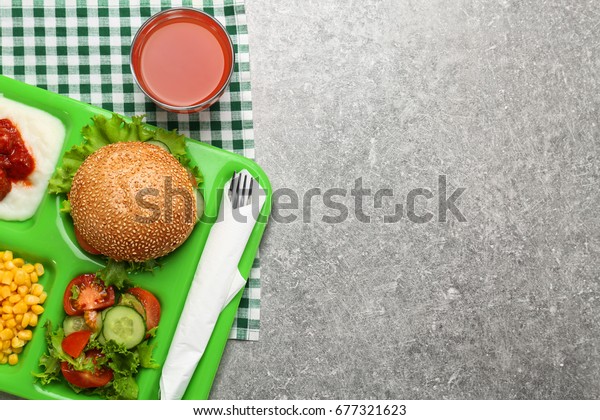 Serving tray with delicious food on table. Concept
of school lunch