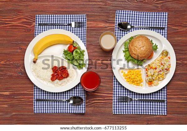 Serving trays with delicious food on table. Concept
of school lunch