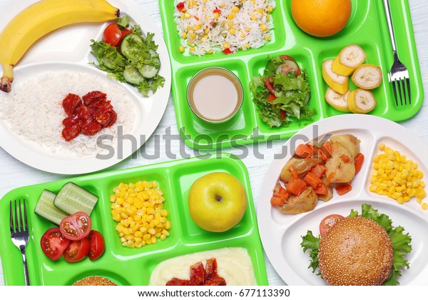 Serving trays with delicious food on table. Concept\
of school lunch