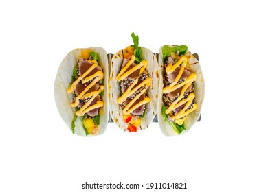 Sesame Crusted Ahi Tuna Tacos With Vegetables In A Soft Flour Tortilla On A White Background