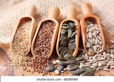  Sesame, Flax, Pumpkin And Sunflower Seeds In Wooden Spoons