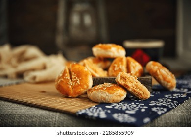 Sesame meat muffins, traditional handmade food, dark background(Translation: The word 
