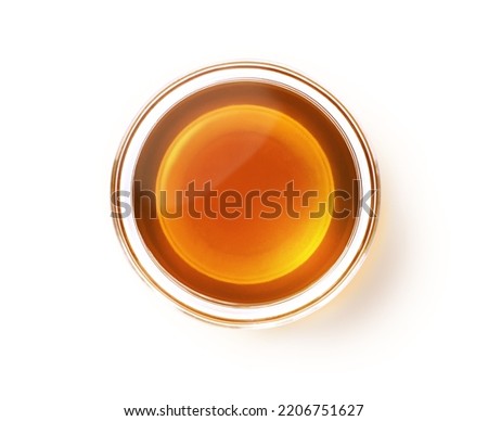 Sesame oil in glass bowl isolated on white background with clipping path. Top view. Flat lay.