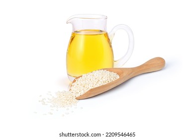 Sesame seed oil in glass jar with white sesame seeds isolated on white background. - Shutterstock ID 2209546465