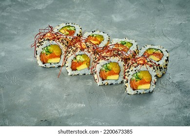 Sesame Sushi Roll With Salmon, Avocado, Cucumber On A Gray Background. Noise Added In Post-production