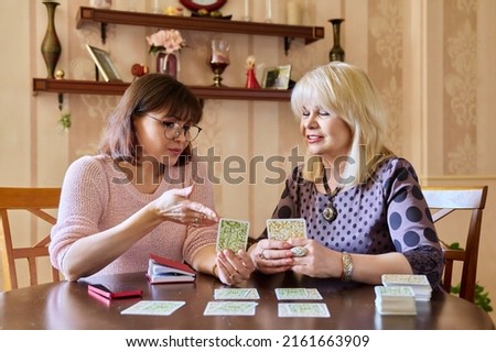 Session of mental therapy, mature female psychologist using metaphorical associative cards