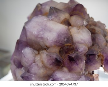 Session of precious minerals and rocks. Macro photo of Amethyst Quartz. Rocks and minerals exhibited in a museum. Gemstones, rocks and jewelry minerals. Reflections and textures of colorful minerals.