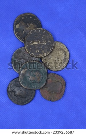 Sestertius, bronze coins of the Roman Empire, on a blue background.