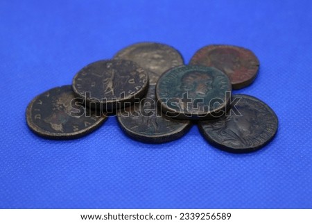 Sestertius, bronze coins of the Roman Empire, on a blue background.