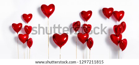 Set of Air Balloons. Bunch of red color heart shaped foil balloons isolated on white background. Love. Holiday celebration. Valentine's Day party decoration. Metallic red  Heart air balloons