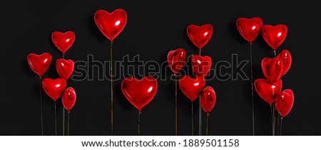 Set of Air Balloons. Bunch of red color heart shaped foil balloons isolated on black background. Love. Holiday celebration. Valentine's Day party decoration. Metallic red  Heart air balloons