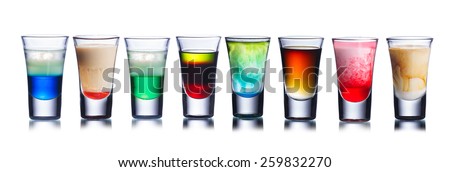 Set of alcoholic cocktails in shot glasses (shooters) isolated on white