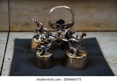 Set Of Antique Silver Altar Bells With Fishes On Top In A Church In Germany