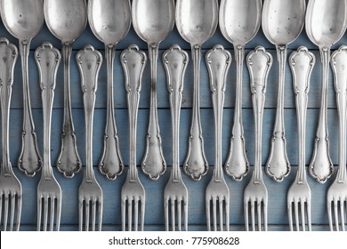 Set of antique silverware from spoons and forks on wooden table. Food concept background