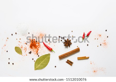 set of assorted colorful spices on a white background, flat lay, top view, with copy spice