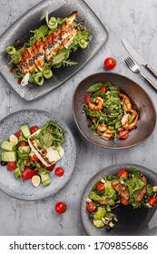 Set Of Assorted Delicious Salads Over Gray Concrete Background. Salad Bar. Overhead View, Flat Lay, Restaurant Menu