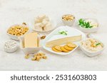 Set of assorted homemade vegan nuts cheese. Raw healthy sauce in a bowl, lactose free food. Bio organic product, plant based diet, alternative lifestyle. Light stone background, copy space