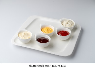 Set Of Assorted Snack Sauces Isolated On White Background: Sour Cream, Mayo, Mustard, Ketchup And Bbq Sauce