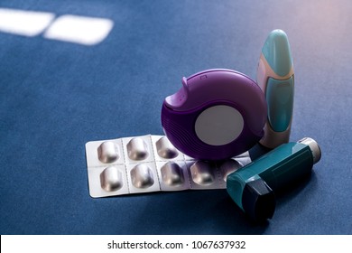 Set Of Asthma Inhaler, Accuhaler And Anti-allergy Pills For Treatment Asthma. Asthma Controller, Reliever Equipment On Dark Blue Background. Bronchodilator And Steroids Drug For Severe Asthma. 