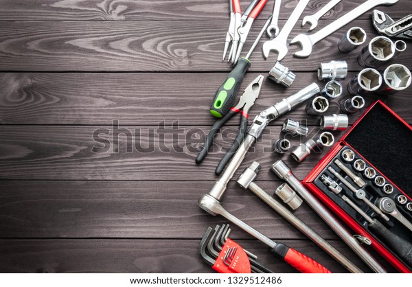 set of\
auto tools on dark wooden workbench. copy\
space