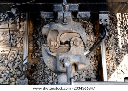 A set of automatic couplers between two caboose.