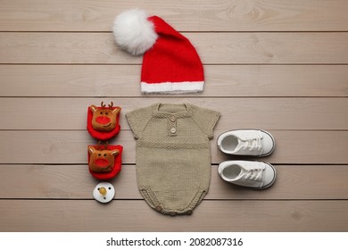 Set Of Baby Clothes For Christmas Photoshoot On Wooden Background, Flat Lay