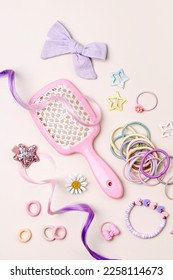 Set of baby girl accessories. Fashion hair bows, hair brush, hair clips, hairpins and hair elastics.  Hairstyles for girls with stylish accessory. 
