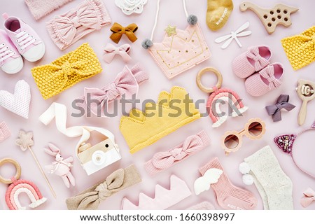 Set of  baby girl accessories on pink background. Various head band and hair bow, toy, little shoes, socks. Fashion kids stuff and accessories. Flat lay, top view