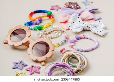Set of baby girl hair accessories. Sunglasses with fashion hair bows, hair clips, hairpins and hair elastics.  Hairstyles for girls with stylish accessory. 