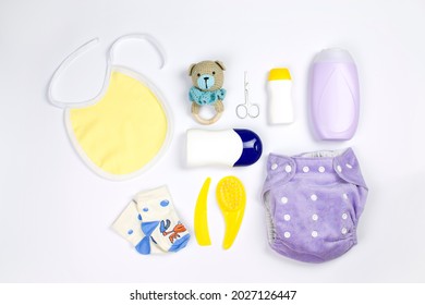 Set with baby hygiene products and bathroom items, shampoo, essential oil, baby soap, bib, socks, combs, reusable diaper and rattle. Accessories for baby hygiene.