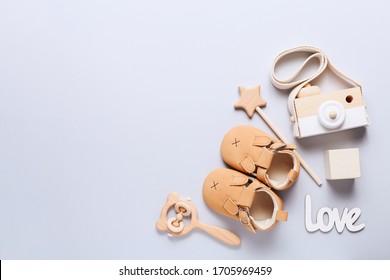 Set Of Baby Shoes, Toys And Accessories On Grey Background. Newborn Stuff. Flat Lay, Top View