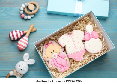 Set Of Baby Shower Cookies In Gift Box And Accessories On Turquoise Wooden Table, Flat Lay